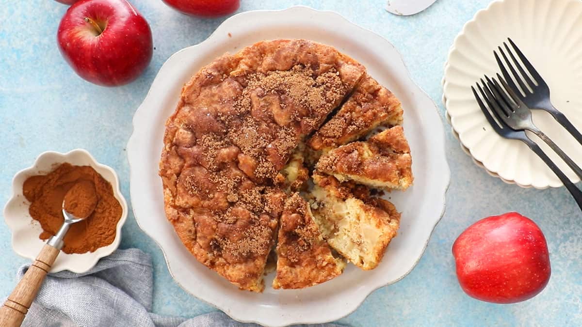 one brown apple cake in a white plate.