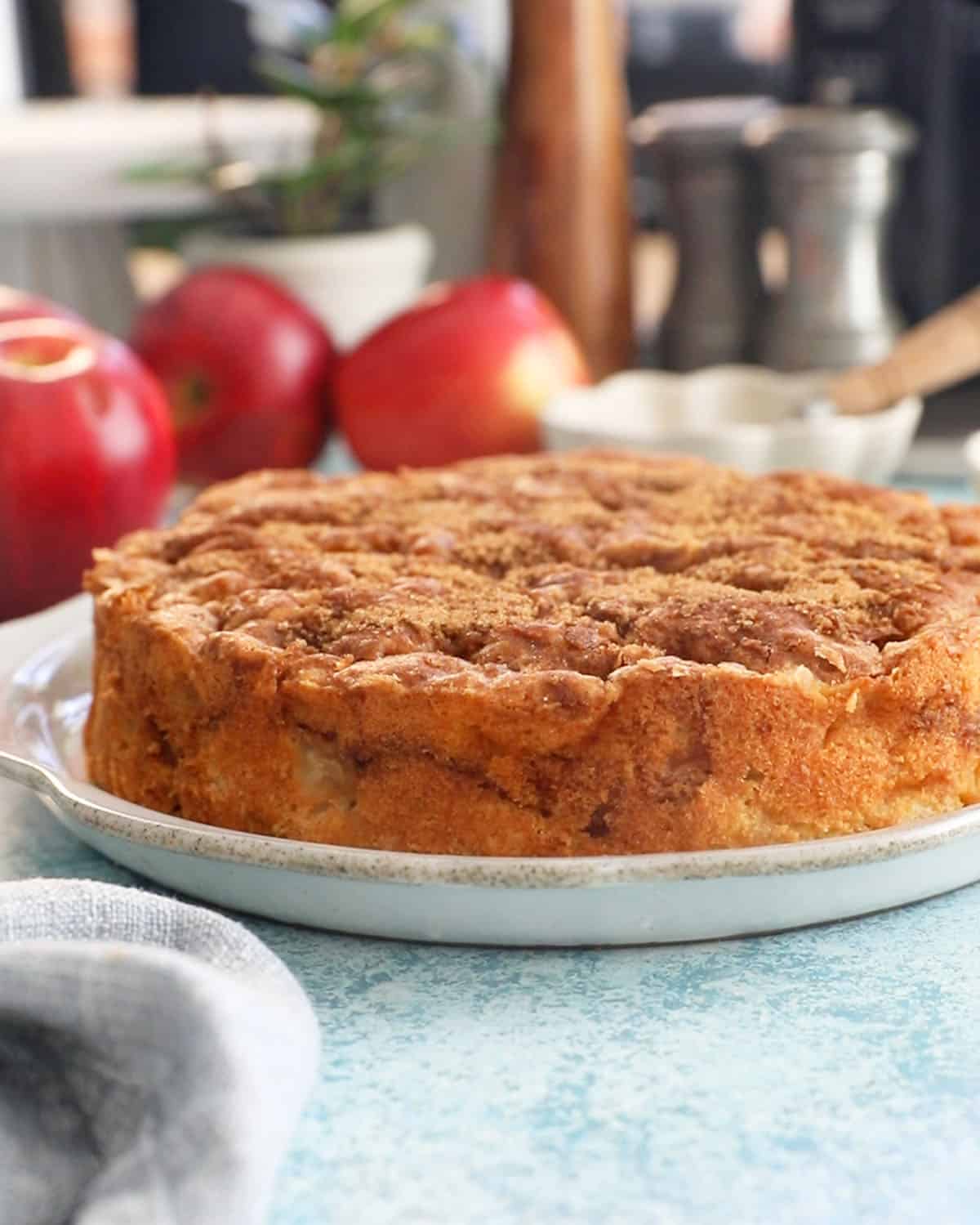 one brown apple cake in a white plate.