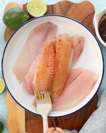 4 pink fish fillets in a white bowl.