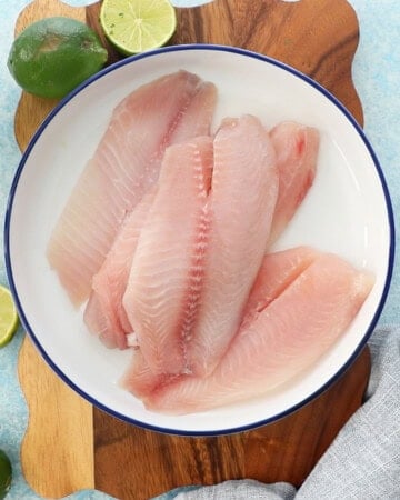 4 pink fish fillets in a white bowl.