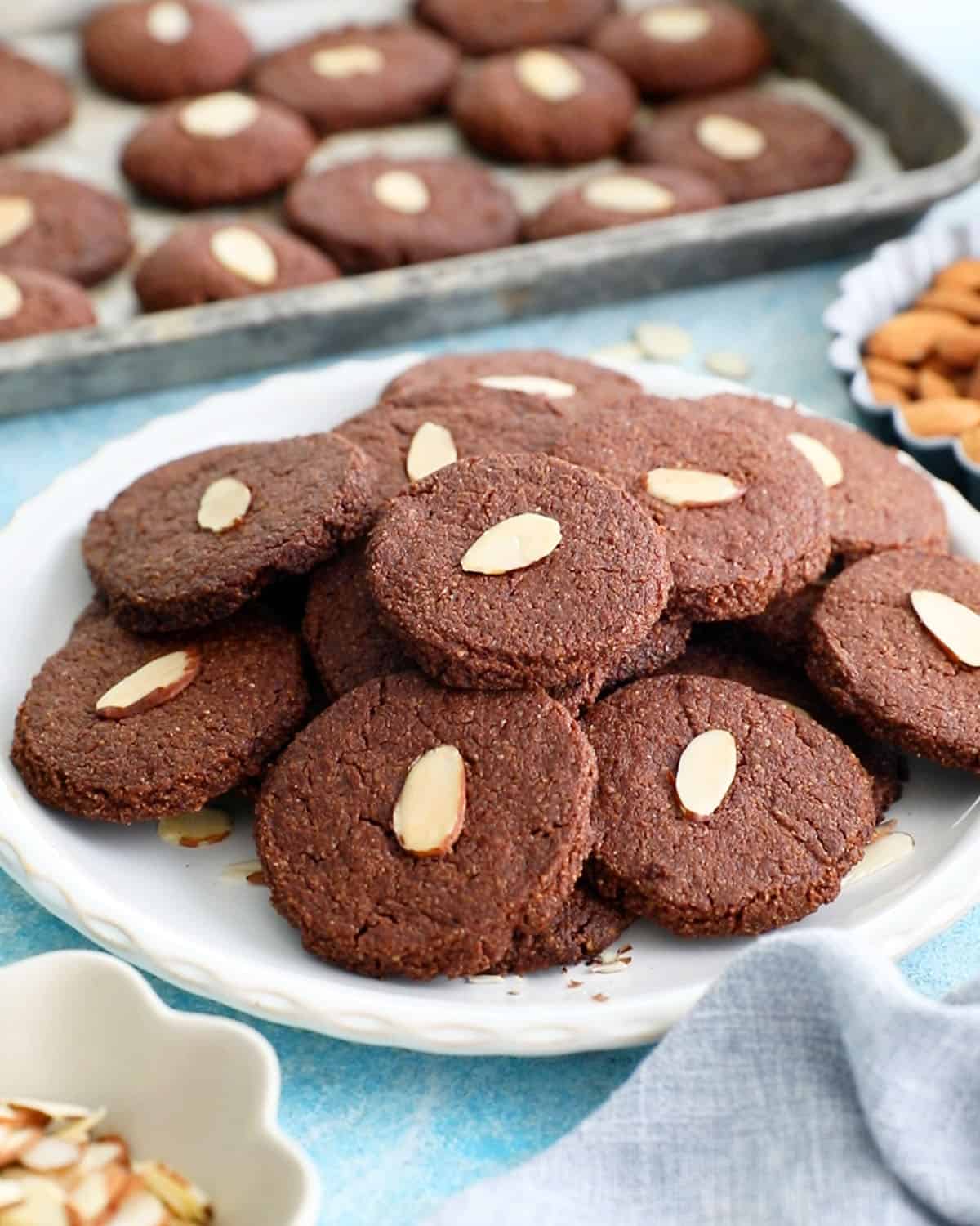 brown almond flour chocolate cookies on a white plate.