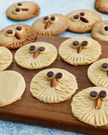 owl cookies on a brown board.