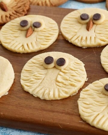 owl cookies on a brown board.