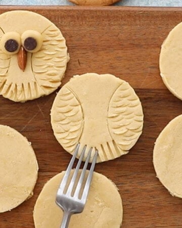 owl cookies on a brown board.