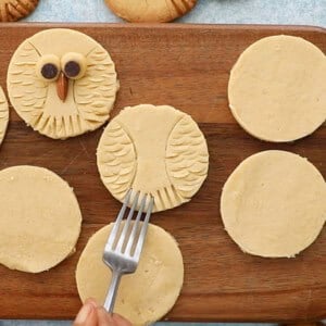 white cookie dough circles on a brown board.
