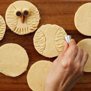 white cookie dough circles on a brown board.