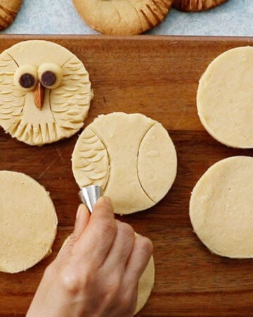 owl cookies on a brown board.