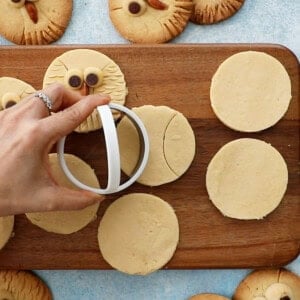 white cookie dough circles on a brown board.